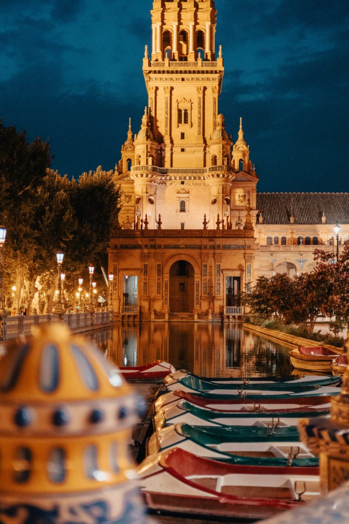 Plaza de España at night in Sevilla, Spain – beautifully lit landmark with reflections on the canal and stunning architecture