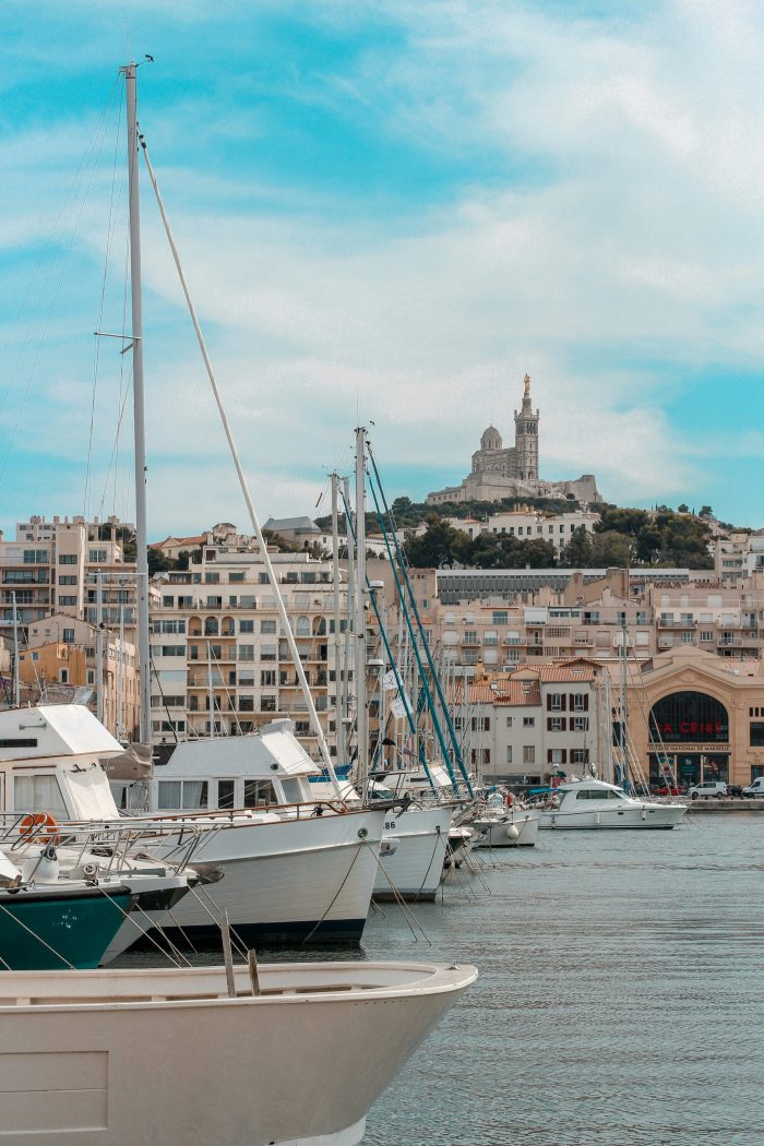 Boats anchored near the beach in Marseille with the Mediterranean sea in the background