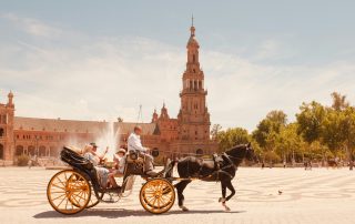 Traditional horse carriage ride in Sevilla, Spain – local guide and tourist exploring the historic city center