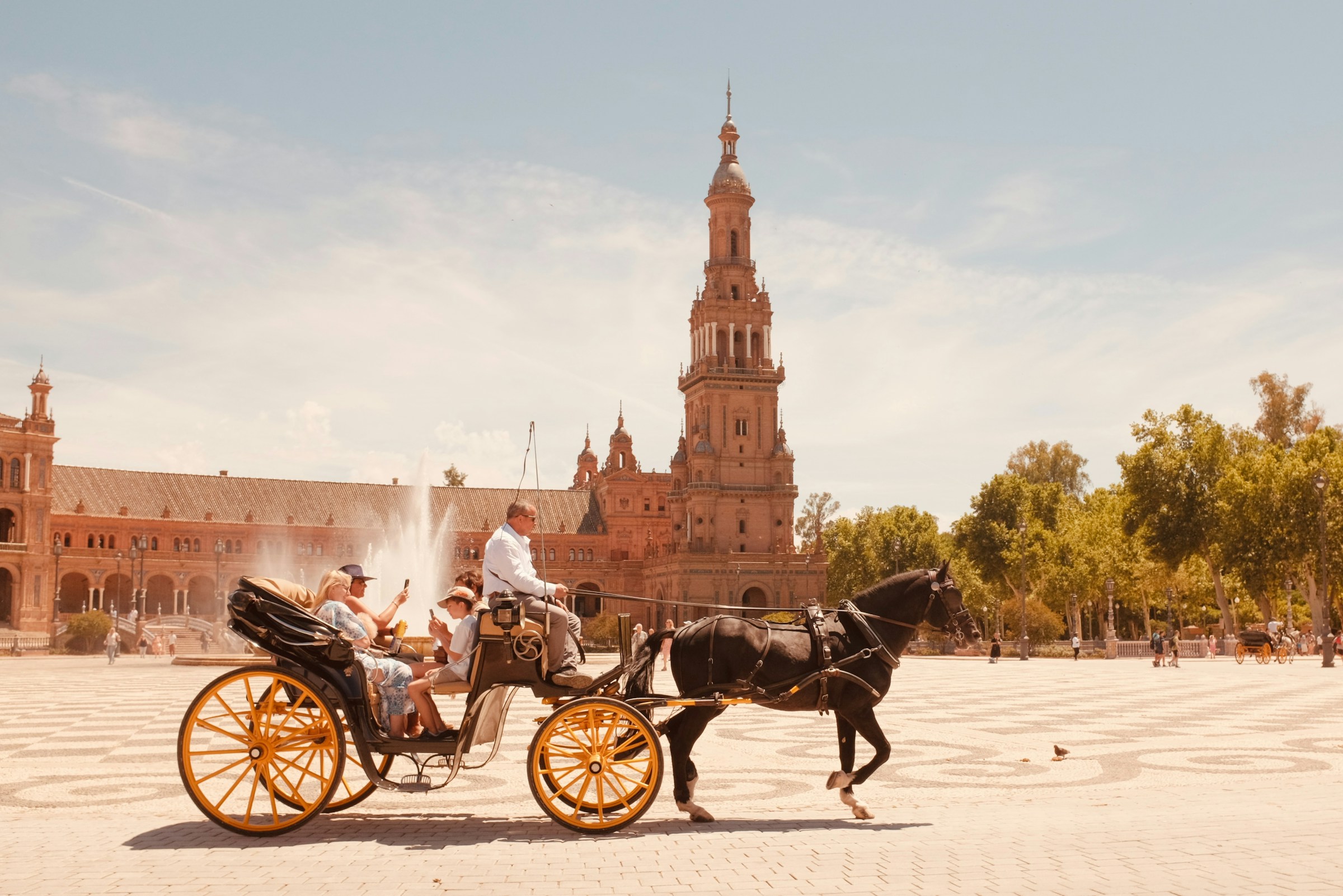 Traditional horse carriage ride in Sevilla, Spain – local guide and tourist exploring the historic city center