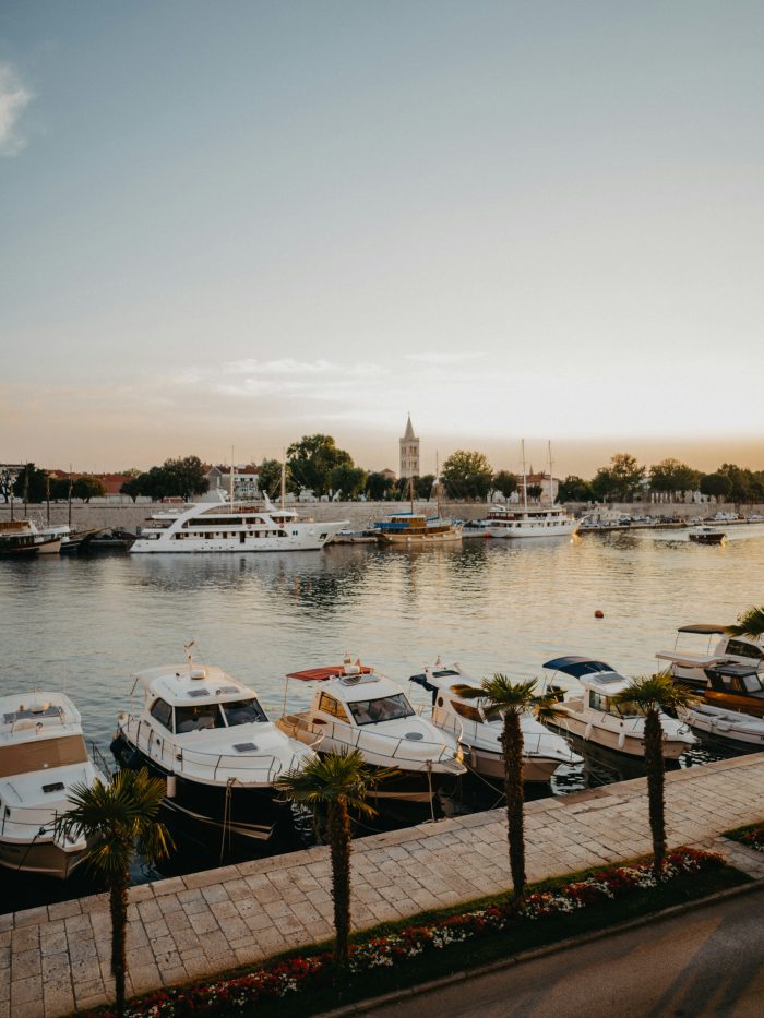Boats docked in the marina of Zadar, Croatia with the Adriatic Sea in the background