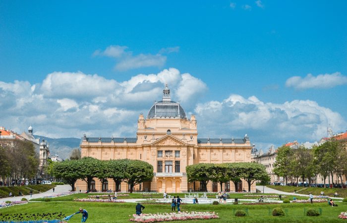 Lush green garden in Zagreb with vibrant trees, colorful flowers, and peaceful walking paths, perfect for relaxation in the city
