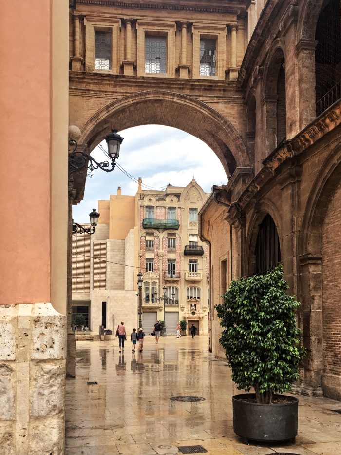 Historic stone archway in Valencia, Spain, showcasing classic Mediterranean architecture.