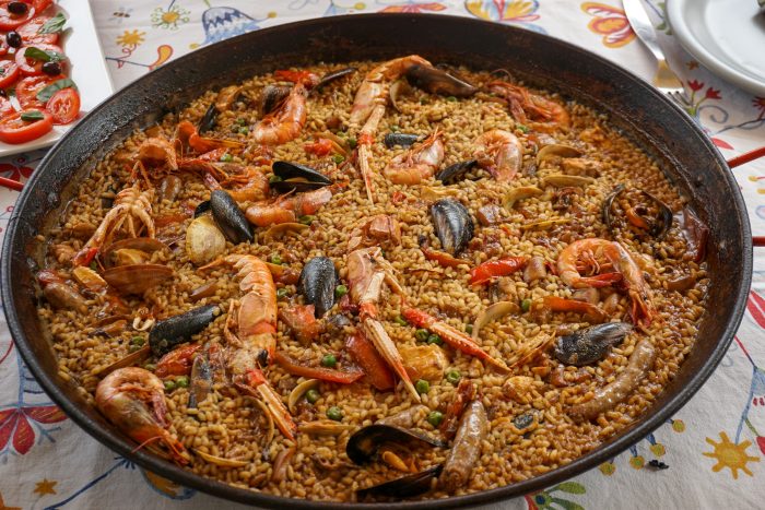Traditional Valencian paella served in a pan with saffron rice, seafood, and vegetables