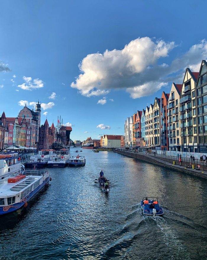 View of Gdańsk cityscape along the Baltic Sea coast with ships and waterfront buildings under a clear sky